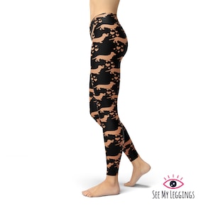 May include: Black leggings with a repeating pattern of brown dachshund silhouettes and hearts.