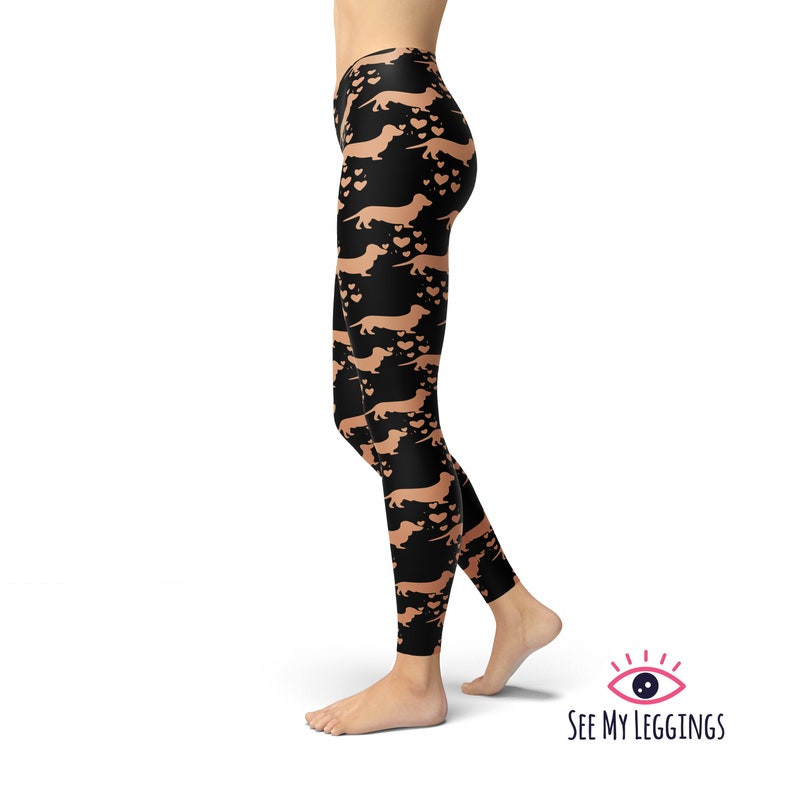 May include: Black leggings with a repeating pattern of brown dachshund silhouettes and hearts.