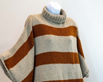 Hand knit winter turtle neck poncho/shawl in sand color with cognac straps. Rectangular form with sleeves.