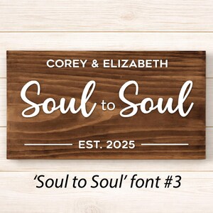 May include: A rectangular wooden sign with the words "COREY & ELIZABETH" above "Soul to Soul" in white script. Below, it reads "EST. 2025". The sign is a dark brown color. The text "'Soul to Soul' font #3" is below the sign.