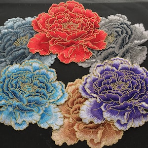 May include: Five embroidered fabric patches featuring different coloured peonies. The patches are in shades of red, blue, purple, grey, and brown.