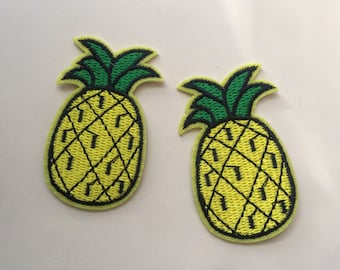 May include: Two yellow pineapple embroidered patches with green leaves.