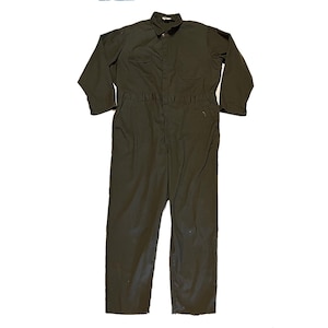 May include: A dark green work jumpsuit with long sleeves and a button-up front.