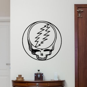 May include: Black and white wall decal of the Grateful Dead's iconic Steal Your Face logo. The logo features a skull with a lightning bolt in the forehead.