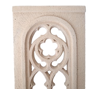 May include: A white stone archway with a decorative, intricate design. The archway is made of a rough, textured stone and has a light, airy feel.
