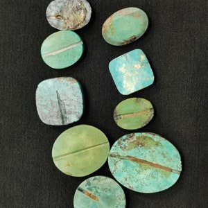 May include: Assortment of nine turquoise cabochons in various shapes and sizes. The cabochons are a mix of green and blue hues with some having a brown or gold veining.