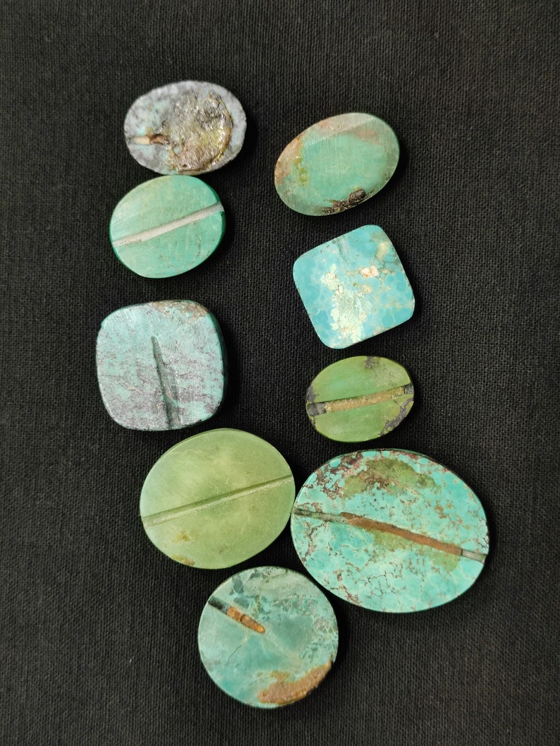 May include: Assortment of nine turquoise cabochons in various shapes and sizes. The cabochons are a mix of green and blue hues with some having a brown or gold veining.