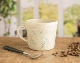 Handmade pottery half pint mug, rustic pottery mug with blue slip decoration.