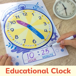 May include: A colorful educational clock with a movable hour and minute hand. The clock face is yellow with blue numbers and a blue and purple outer ring. The clock is set to 10:25. The text "What time is it?" is written at the top of the clock.