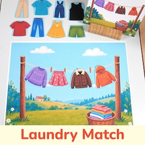 Könnte beinhalten: Ein Laundry Match Lernspiel-Set mit einer großen illustrierten Karte, die eine Wäscheleine, einen Korb mit gefalteter Kleidung und eine ländliche Landschaft zeigt. Enthält mehrere einzelne Papier-Ausschnitte verschiedener Kleidungsstücke wie Oberteile und Röcke.