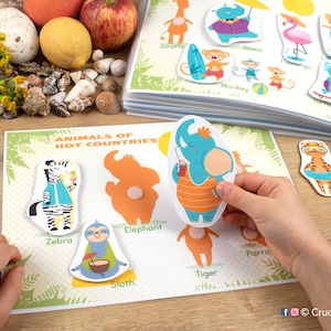 May include: A colorful educational game for kids featuring animals from hot countries. The game includes a board with images of a giraffe, rhino, flamingo, elephant, zebra, monkey, parrot, sloth, and tiger. Each animal has a corresponding cutout piece that can be matched to the correct image on the board.