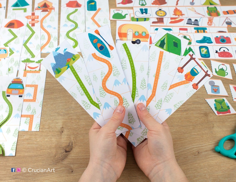 May include: A set of printable camping themed game cards featuring a variety of images including a camper, a tent, a campfire, a canoe, and a mountain scene. The cards are designed to be used for a matching game or other activities.