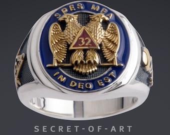 May include: A silver Masonic ring with a blue enamel design featuring two golden eagles flanking a red triangle with the number 32. The inscription "SPES MEA IN DEO EST" is around the outer edge of the ring.
