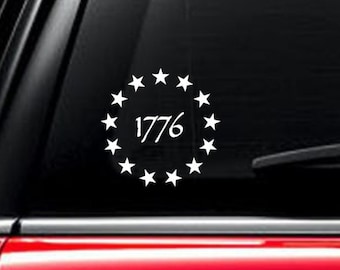 May include: White vinyl decal with a circle of thirteen stars surrounding the year 1776.