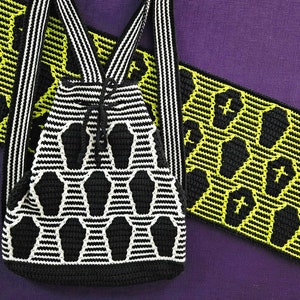 May include: A black and white crocheted backpack with a yellow and black crocheted strap. The backpack has a coffin pattern.