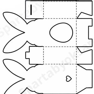 May include: A white ceramic mug with a black handle and the text "But First, Coffee" in a bold, black font. The mug is set against a blurred background. The mug appears to be approximately 10 cm tall.