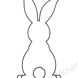May include: A black and white outline of a rabbit silhouette, seen from the rear. The rabbit features long ears and a fluffy tail, and is mounted on a rectangular base. Ideal for Easter decorations or craft projects.