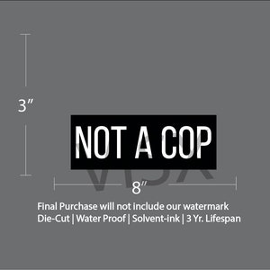 May include: Black and white die-cut vinyl sticker that reads "NOT A COP" with dimensions of 3 inches by 8 inches.  The sticker is water-proof and made with solvent-ink for a 3 year lifespan.