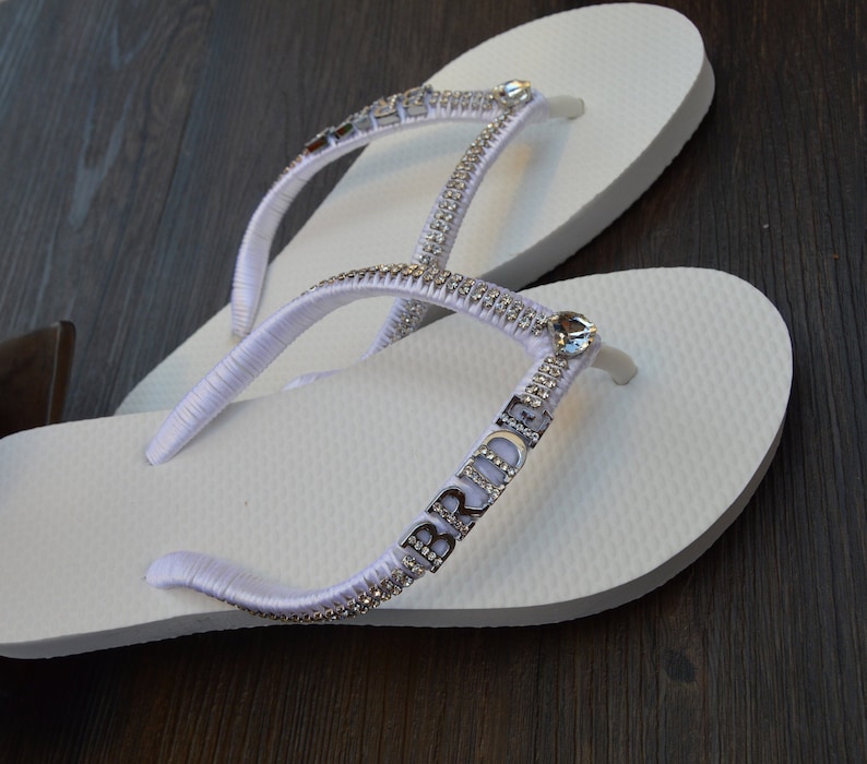 white flat flip flops