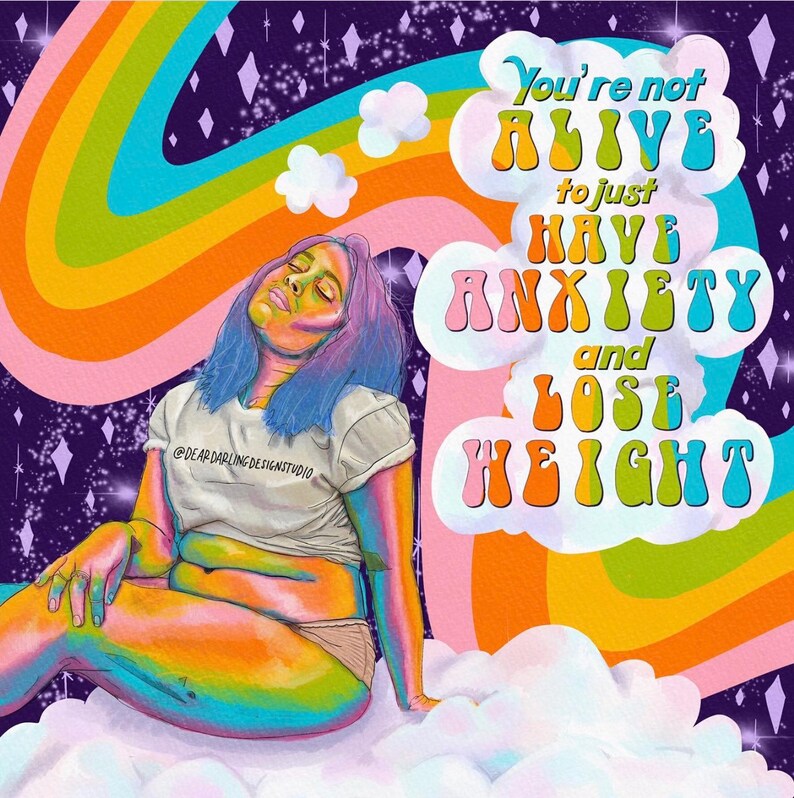 May include: A colorful illustration features a person with blue hair and rainbow skin, sitting on a cloud. A rainbow arches across the background, with text that reads "You're not ALIVE to just HAVE ANXIETY and LOSE WEIGHT." The shirt says "@DEAR DARLING DESIGN STUDIO."