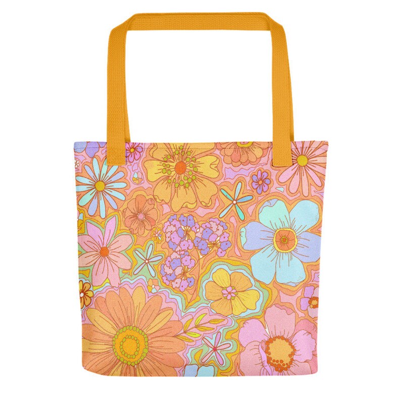 May include: A tote bag with a colorful floral pattern in shades of orange, pink, yellow, and blue. The bag has a solid orange handle and a matching floral design on the front and back.