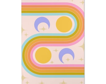 May include: A rectangular wall art print with a retro design. The artwork features a wavy, multi-colored stripe pattern in shades of orange, pink, blue, and yellow, with two yellow circles and two purple crescent moons. Gold star shapes are scattered across a light pink background.