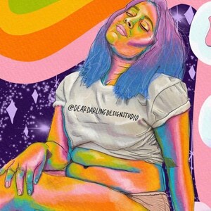 May include: Illustration of a person with blue hair and rainbow-colored skin, wearing a white t-shirt with the text "@DEARDARLINGDESIGNSTUDIO". The background features a rainbow, clouds, and a starry sky. The artwork has a whimsical and colorful aesthetic.