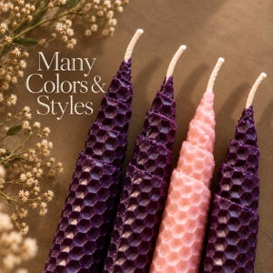 May include: Four tapered candles with a textured honeycomb pattern. Three candles are deep purple and one is light pink. Each candle features a white cotton wick at the top. The text "Many Colors & Styles" is printed in white on the left side.