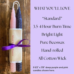 May include: Two hand-rolled beeswax taper candles, one light pink and one deep purple, featuring a honeycomb texture and cotton wicks. They are wrapped in a paper band with a purple ribbon. Text includes: WHAT YOU'LL LOVE, Standard, 3.5-4 Hour Burn Time.