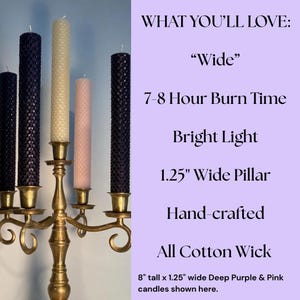 May include: A brass candelabra holding five textured pillar candles in shades of deep purple, cream, and light pink. Text on the right lists features: Wide, 7-8 Hour Burn Time, Bright Light, 1.25 inch Wide Pillar, Hand-crafted, All Cotton Wick, 8 inch tall.