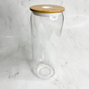 May include: A clear glass jar with a bamboo lid. The lid has a white silicone seal and a white plastic ring.