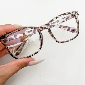 May include: Leopard print square-shaped glasses with clear lenses.