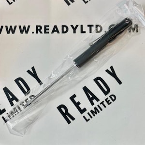 May include: A dark gray pen with a clip, packaged in clear plastic. The pen is long and slender, with a metallic finish. The packaging is on a white surface with the text "READY LIMITED" and "WWW.READY LTD.COM" printed in black.