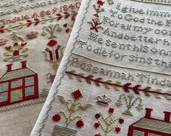 May include: Two pieces of cross-stitch embroidery, one with a red and white house and the other with a verse of scripture. The verse reads "We give immortal praise to God the King of all my heart and better hope we sent his only Son to die for sins that.
