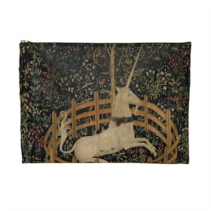 May include: A white unicorn with a gold collar is lying down in a circular wooden fence. The unicorn is surrounded by a lush green forest with colorful flowers. The background is a dark green tapestry.