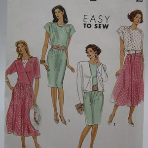 May include: Simplicity sewing pattern number 704 for sizes 10-18. The pattern includes three different dress designs: a pink polka dot dress with a wrap style bodice, a green dress with a scoop neck and short sleeves, and a green dress with a white jacket and a scoop neck.