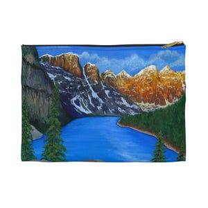 May include: A painting of a mountain lake scene with a blue lake, snow-capped mountains, and green trees. The mountains are a mix of brown, gray, and white. The lake is a bright blue and reflects the sky. The trees are a dark green and line the shore of the lake.