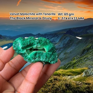 May include: A bright green Velvet Malachite with Tenorite, weighing 69 grams. The stone measures 5.7x4.1x3.3 cm. The Black Mineral & Druzy is shown against a mountain landscape.