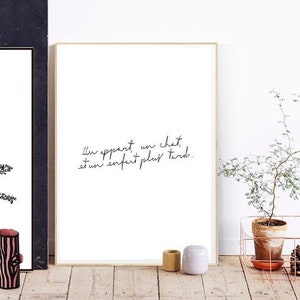 May include: A framed print with a white background and black text that reads "Il y a part un chat, et un enfant plus tard."