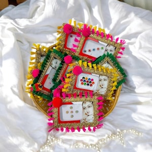 May include: Assortment of small, decorative frames with colorful embellishments and images of women's faces. Each frame contains a sheet of small, colorful adhesive gems.