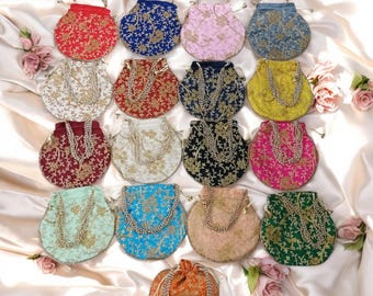May include: Assortment of 17 round drawstring bags with beaded handles. The bags are made of various fabrics and feature embroidered floral designs in a variety of colors, including red, blue, pink, yellow, green, and gold.