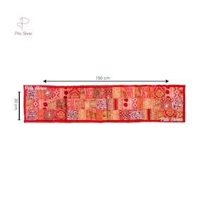 May include: Red patchwork table runner with gold embroidery, measuring 59 inches long and 12 inches wide. The runner features a variety of colorful patterns and textures.