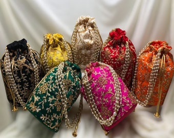May include: Set of seven embroidered drawstring bags with pearl trim. The bags are in various colors, including black, yellow, white, red, green, pink, and orange.