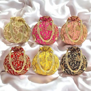 May include: Six embroidered drawstring pouches in various colours, including pink, red, yellow, black, and cream. Each pouch has a gold beaded drawstring and intricate floral embroidery.