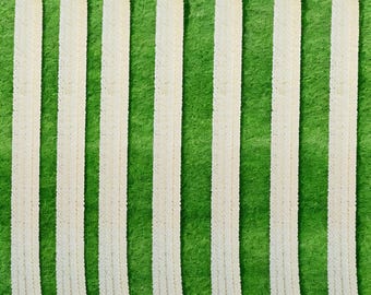 May include: Ten white flower garlands arranged vertically against a green background. The garlands are made of small white flowers and are approximately 90 cm long.