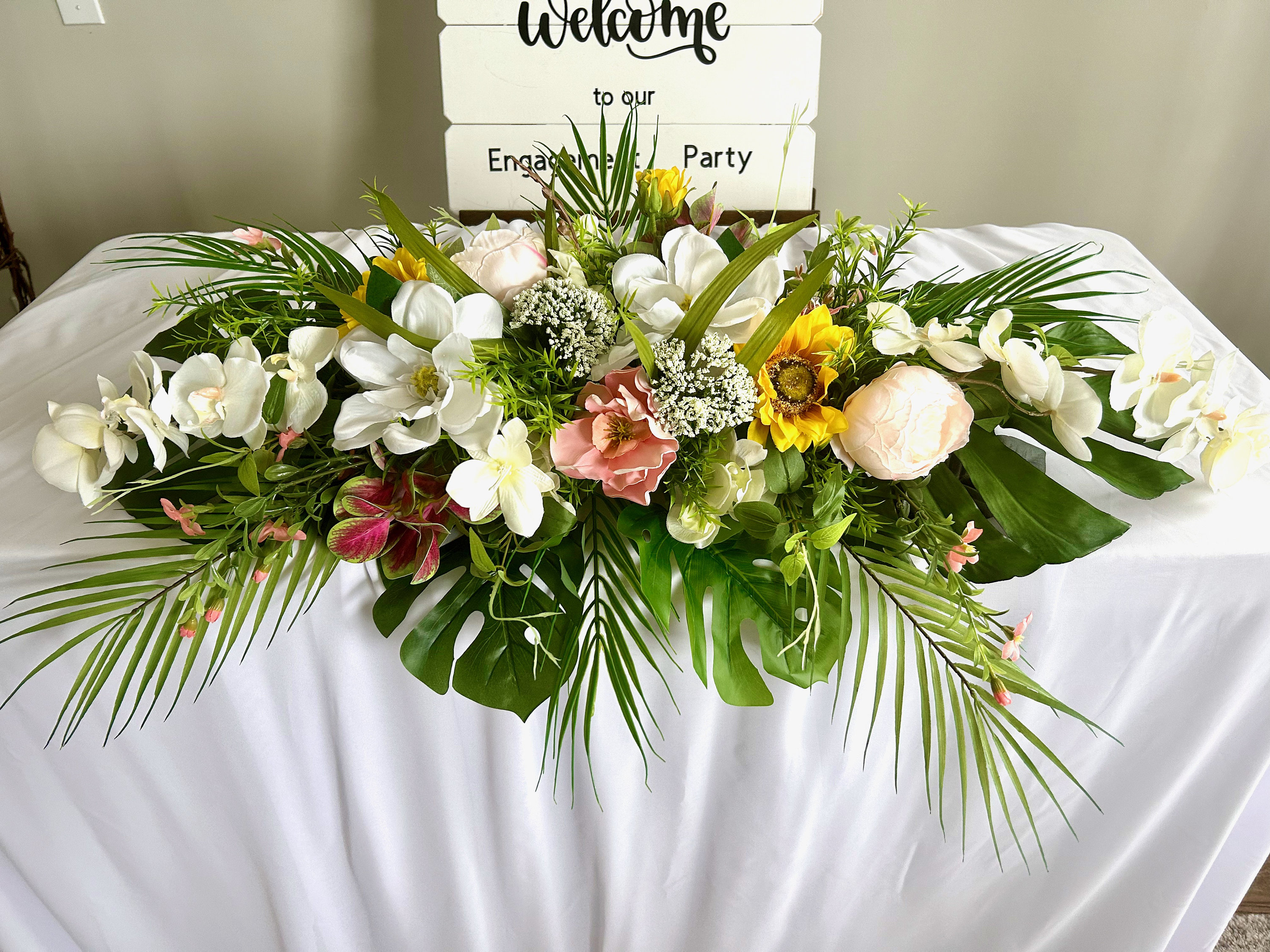 Sweetheart Table Arrangement Made With Tropical Foliages and