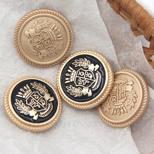 May include: Four gold-colored buttons with a black center. Each button features a gold-colored crest with a crown, shield, and leaves. The buttons have a rope-like border.