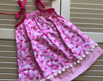 Tara - Casual Girls Sundress, Pillowcase Dress, Pink Flamingo Fabric Pattern, White Pom-Pom Trim, Pink Checkered Bottom