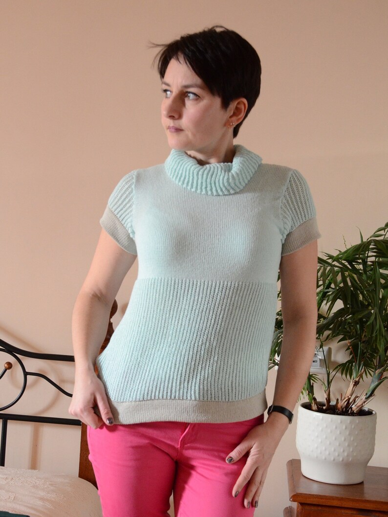 Summer Knitted cotton Blouse with short sleeves and turtleneck in aero blue color and lightgray inserts with amusing pattern for women
