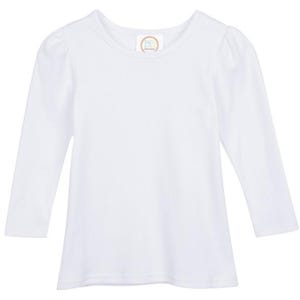 May include: A white long-sleeved top with a round neck and gently puffed sleeves. The shirt features a small, circular logo near the neckline. The sleeves reach the wrists.